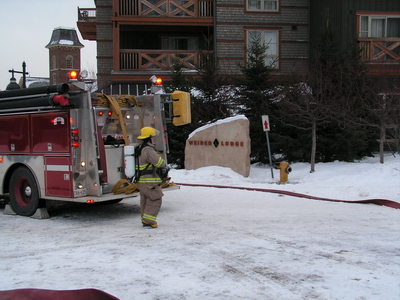 Seen here starting to pick up hoses from the fire as they won't need them from this truck.